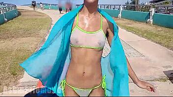 Hairy latina flashes pussy and tits underwater at beach