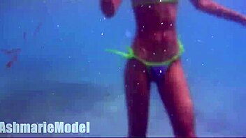 Hairy latina flashes pussy and tits underwater at beach