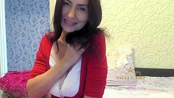 horny mature brunette with hairy pussy strips on couch for fans