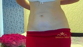 horny mature brunette with hairy pussy strips on couch for fans