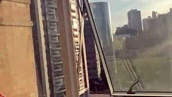 A Brazilian couple fucks bareback at the window for neighbors