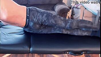Stretching in tight leggings on massage table HD
