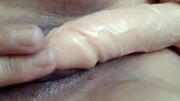 Big pussy lips gape wide as I rub two huge dildos against shaved vagina