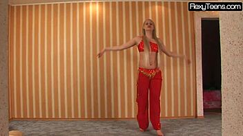 Sexy Russian blonde belly dancer stretches flexible body in red dress