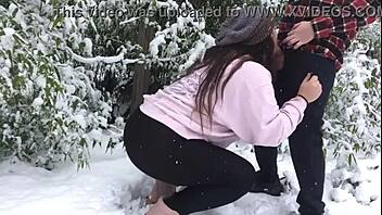 real couple enjoys snowy outdoor adventure together.
