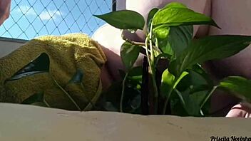 naked tattooed babe waters plants on balcony flashing tits