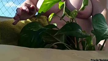 naked tattooed babe waters plants on balcony flashing tits