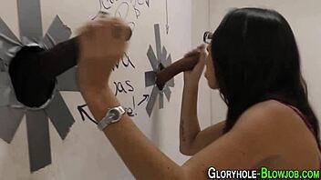 woman takes big black cocks at the gloryhole booth