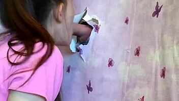 our first homemade gloryhole lets brunette suck cock through walls intensely
