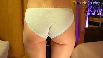 Teasing skinny blonde's panty-covered booty softly