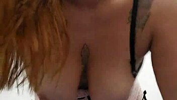 Hot redhead flashes her perky tits and pink pussy