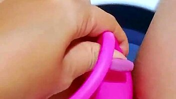 Pretty teen fingers her shaved pink pussy in office bathroom