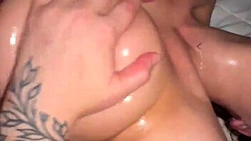 man cums on woman's big tits during shower blowjob session