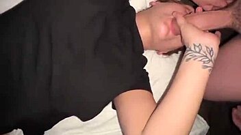 man cums on woman's big tits during shower blowjob session