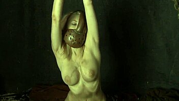 Chained Cosplay Babe Masturbates Shaved Pussy in Bondage