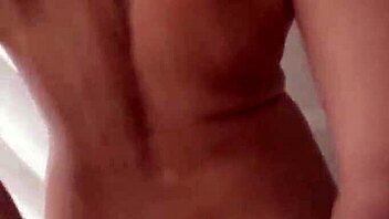 man cums on woman's big tits during shower blowjob session