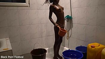 Dolcina seductively showers her skinny African tits and curves