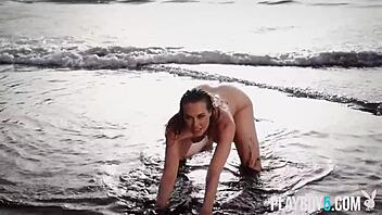 german milf jasmin strips naked on beach showing off her bombshell body?