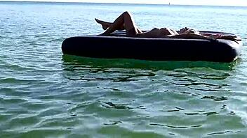 beautiful blonde big boobs nudist poses naked on beach with dolphins tattoo.