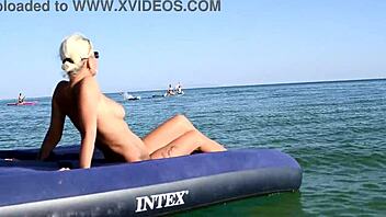 beautiful blonde big boobs nudist poses naked on beach with dolphins tattoo.