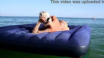 beautiful blonde big boobs nudist poses naked on beach with dolphins tattoo.