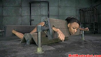Bound ebony babe spanked hard in pillory while vibed deep