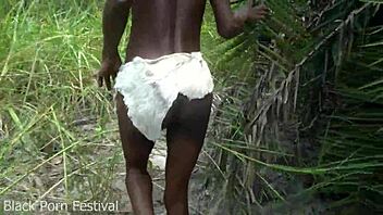 Skinny ebony African tribe girl labors outdoors with narrow ass