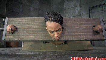 Bound ebony babe spanked hard in pillory while vibed deep