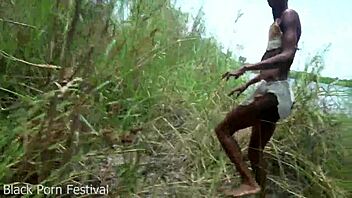 Skinny ebony African tribe girl labors outdoors with narrow ass