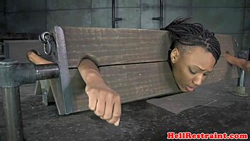 Bound ebony babe spanked hard in pillory while vibed deep