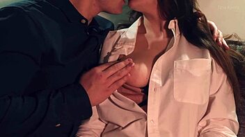 couple kisses necks and licks nipples in bedroom foreplay