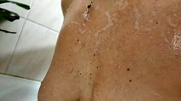 mature slut showers sucking dick rubbing cum on big tits