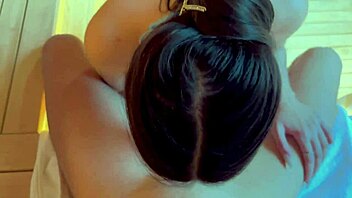 curvy brunette couple relaxes intimately in the sauna