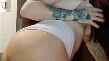 Tattooed redhead shows off tan lines while teasing her big ass closeup
