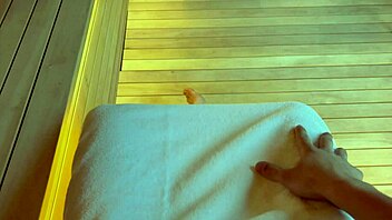 curvy brunette couple relaxes intimately in the sauna