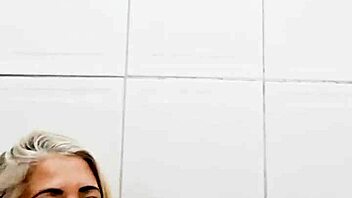 blonde milf shoves dildo deep in pussy in bathroom solo