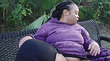 Ebony slut squirts big clit pussy with dildo on public bench!