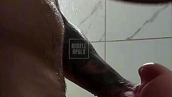 a masked tattooed man takes a shower alone and enjoys playing with his toy until he cums