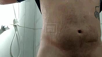 a masked tattooed man takes a shower alone and enjoys playing with his toy until he cums
