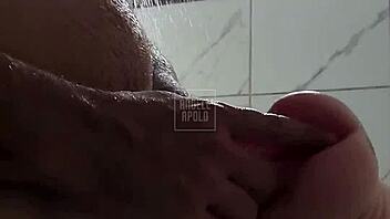 a masked tattooed man takes a shower alone and enjoys playing with his toy until he cums