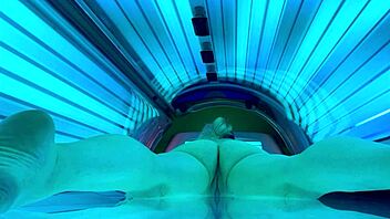 woman relaxes in public tanning bed