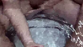 Curvy woman fingers herself wet in the bathtub