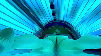 woman relaxes in public tanning bed