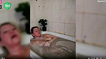 Aimee shaves and fingers her mature pussy in the shower