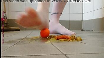 Feet play with fruit in pantyhose feels good