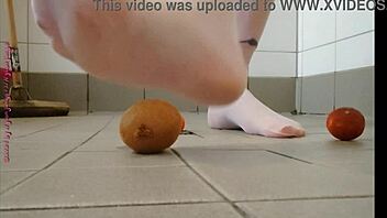 Feet play with fruit in pantyhose feels good