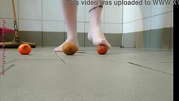 Feet play with fruit in pantyhose feels good