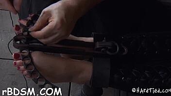 Shackled up hottie is punished in rough bondage
